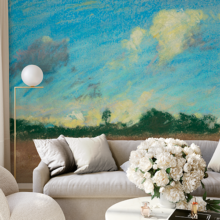 Jitterbug's wallpaper mural of Walter Clark's pastel, Landscape, hangs on the wall of a living area with a sofa and table.