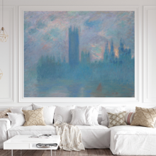 Jitterbug's wallpaper mural of Claude Monet's painting, Houses of Parliament, London, hangs on the wall of a room with a white sofa.