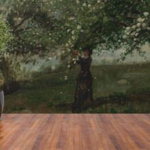 Jitterbug’s wallpaper mural of Winslow Homer's painting, Girl Picking Apple Blossoms hangs on the wall.
