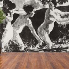 Jitterbug wallpaper mural of Camille Pissarro's painting Bathers Wrestling (Baigneuses luttants) hangs on the wall.