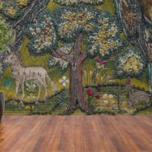 Jitterbug wallpaper mural of 1607 Bible Cover hangs on the wall.